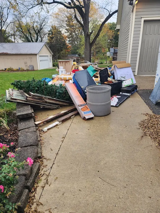 Dumpster being loaded with debris for Estate Cleanout Dumpster Rental in Rollin